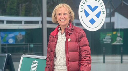 Susan Murray MP standing next to a A board reading the words Susan Murray MP Advice Surgery.