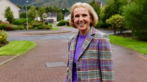 Susan in check jacket with hill in background