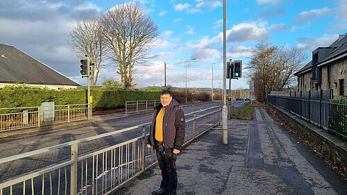 Marthos Christoforou standing by a light controlled road crossing.