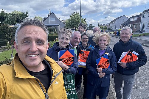 Alex Cole-Hamilton and Susan Murray out with a team of Scottish Lib Dem canvassers holding clipboards.