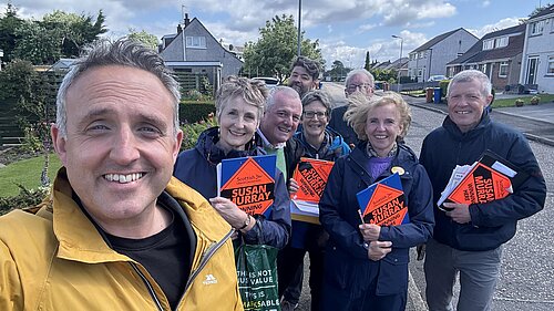 Alex Cole-Hamilton and Susan Murray out with a team of Scottish Lib Dem canvassers holding clipboards.