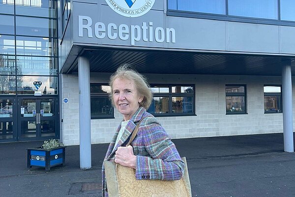 Susan Murray with a bag over her shoulder as she is outside the reception of Bishopbriggs Academy.